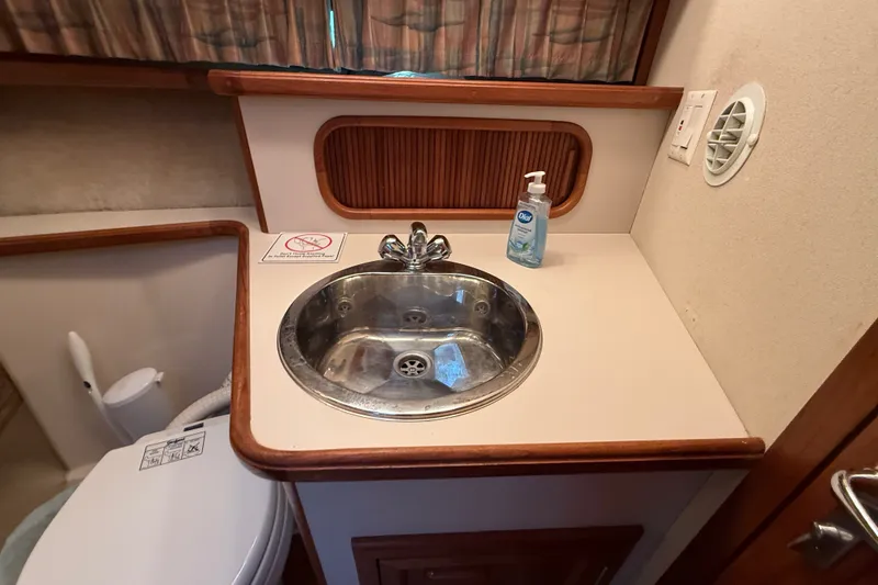 Slide: The Image of 1989 Carver 3807 Aft Cabin Motor Yacht bathroom with sink and toilet. - 54
