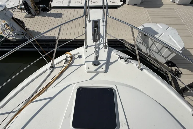 Slide: The Image of 1989 Carver 3807 Aft Cabin Motor Yacht bow at dock, showing deck and railing. - 6