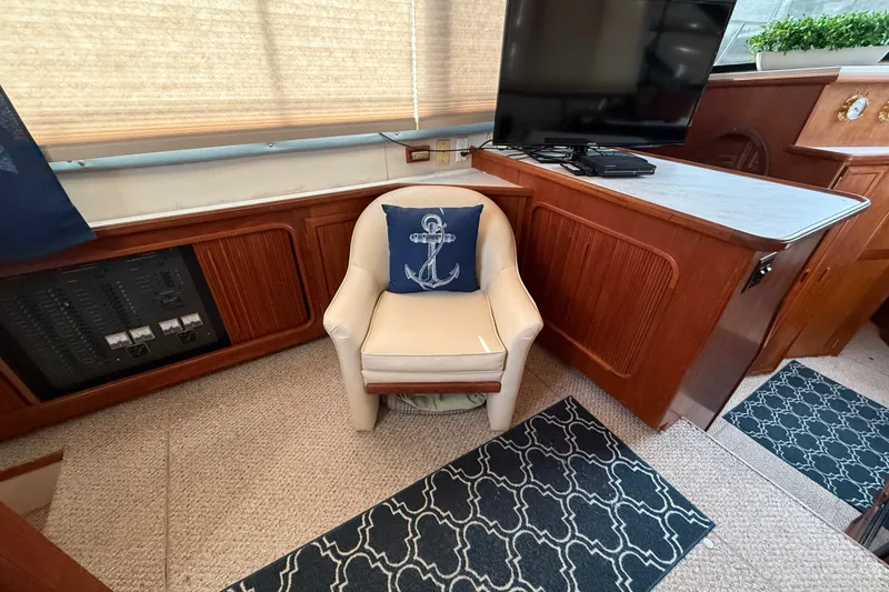 Slide: The Image of Interior of 1989 Carver 3807 Aft Cabin Motor Yacht with chair and TV. - 33