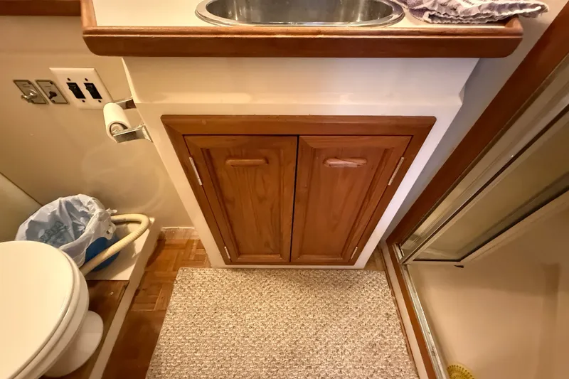 Slide: The Image of 1989 Carver 3807 Aft Cabin Motor Yacht bathroom with sink, cabinet, and shower. - 66
