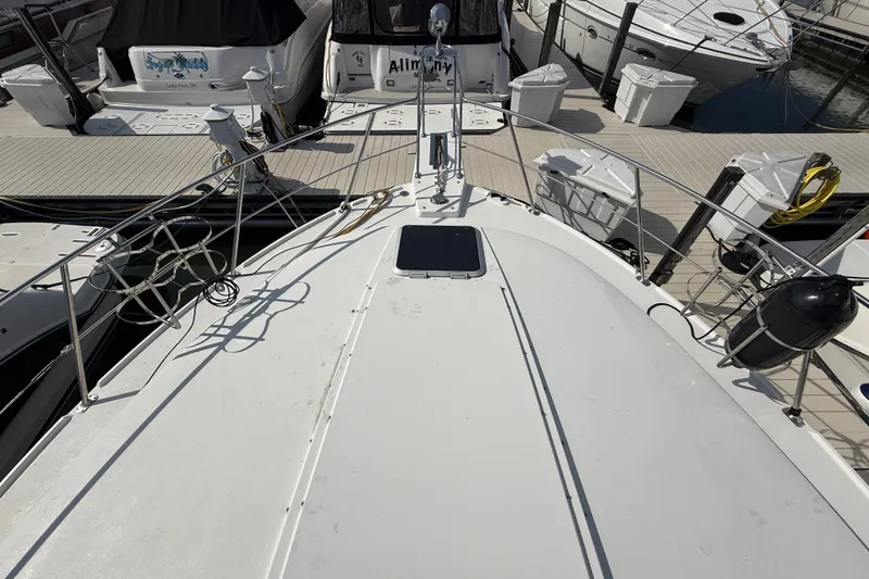 Slide: The Image of 1989 Carver 3807 Aft Cabin Motor Yacht docked at marina, top deck view. - 5