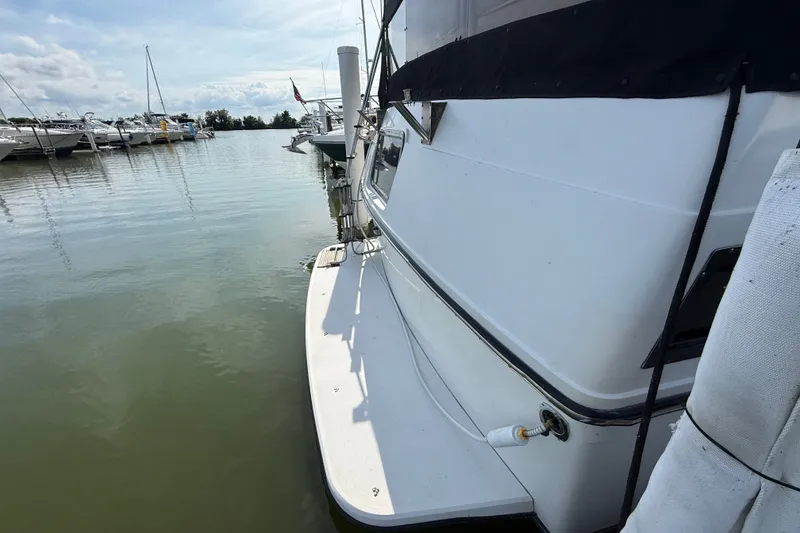 Slide: The Image of 1989 Carver 3807 Aft Cabin Motor Yacht docked at marina, side view. - 7