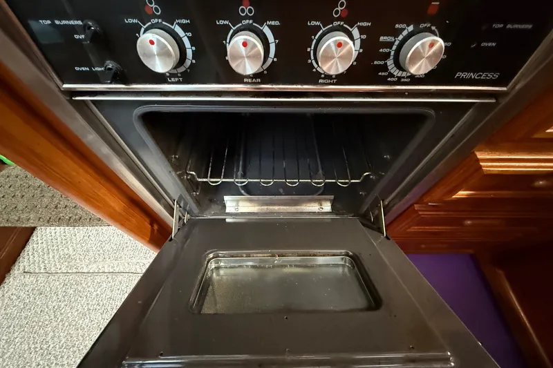 Slide: The Image of Oven with control knobs inside 1989 Carver 3807 Aft Cabin Motor Yacht. - 46
