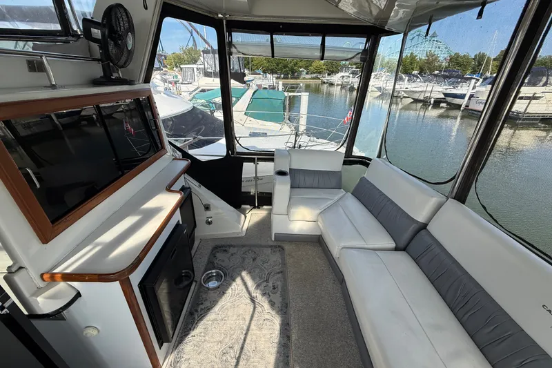 Slide: The Image of Interior of 1989 Carver 3807 Aft Cabin Motor Yacht with seating and marina view. - 13