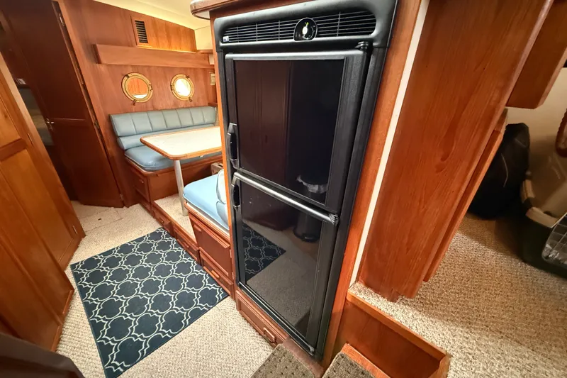 Slide: The Image of Interior of 1989 Carver 3807 Aft Cabin Motor Yacht with dining area and refrigerator. - 42