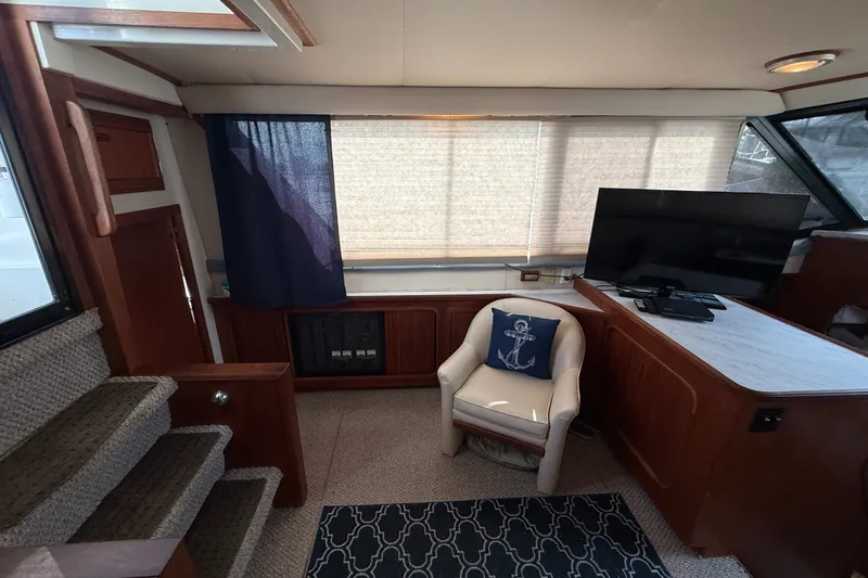 Slide: The Image of Interior of 1989 Carver 3807 Aft Cabin Motor Yacht with TV and seating area. - 34