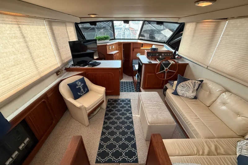 Slide: The Image of 1989 Carver 3807 Aft Cabin Motor Yacht interior with cozy seating and nautical decor. - 27
