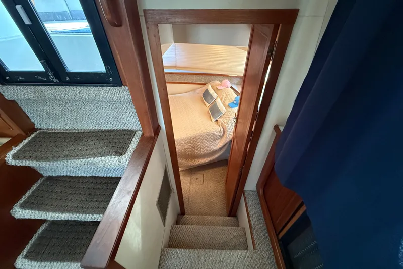 Slide: The Image of Staircase leading to cozy cabin interior on 1989 Carver 3807 Aft Cabin Motor Yacht. - 61