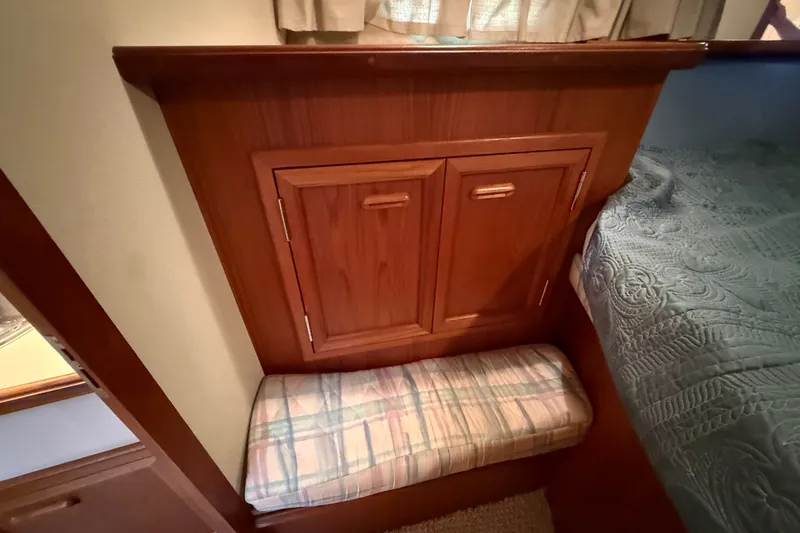 Slide: The Image of 1989 Carver 3807 Aft Cabin Motor Yacht interior with wooden cabinetry and cushioned seating. - 58