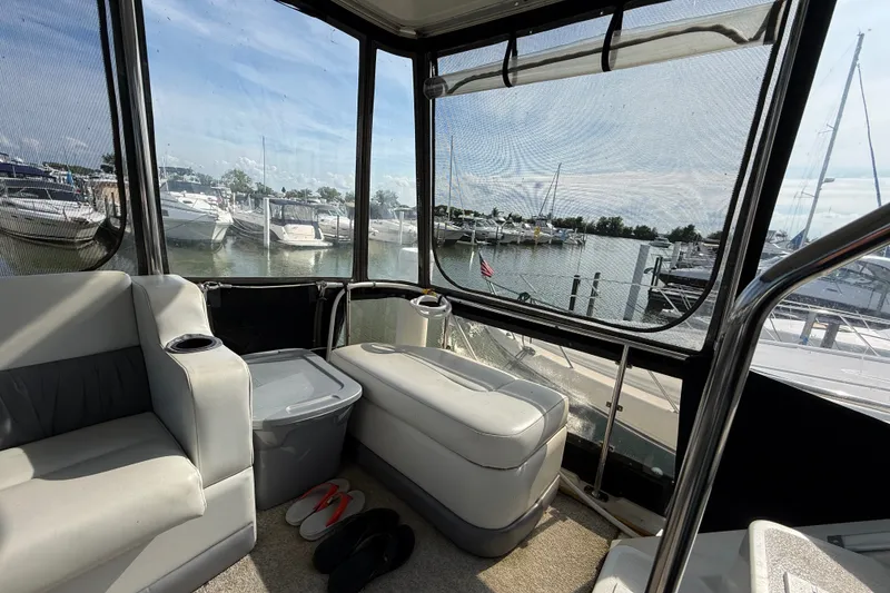 Slide: The Image of Interior view of 1989 Carver 3807 Aft Cabin Motor Yacht with marina backdrop. - 12