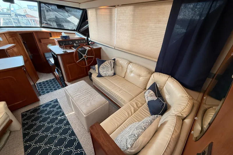 Slide: The Image of Interior of 1989 Carver 3807 Aft Cabin Motor Yacht with plush seating and nautical decor. - 26