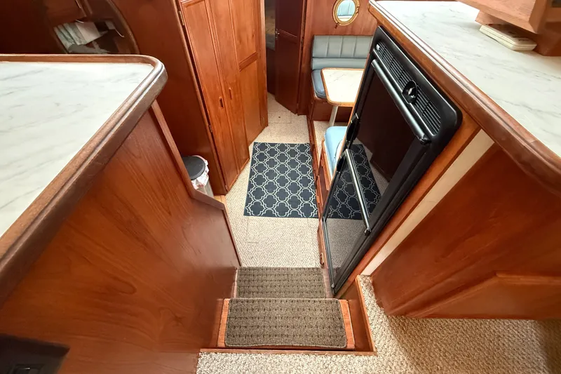 Slide: The Image of 1989 Carver 3807 Aft Cabin Motor Yacht interior with wood finish and cozy seating area. - 41