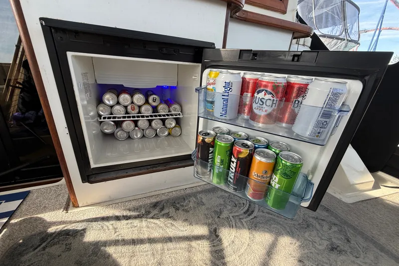 Slide: The Image of Mini fridge stocked with assorted beverages on a 1989 Carver 3807 Aft Cabin Motor Yacht. - 15