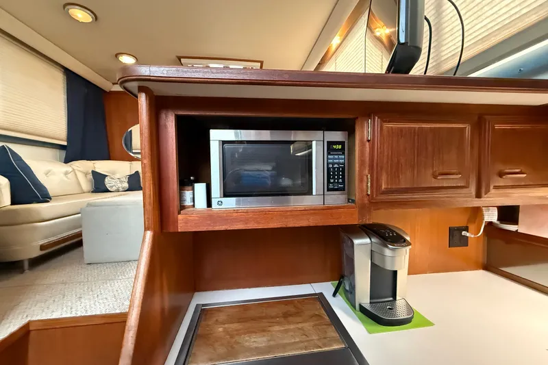 Slide: The Image of 1989 Carver 3807 Aft Cabin Motor Yacht interior with microwave and coffee maker. - 47