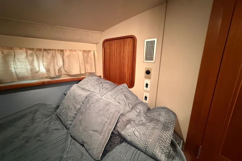 Slide: The Image of Cozy bedroom in 1989 Carver 3807 Aft Cabin Motor Yacht with elegant bedding and wood accents. - 57