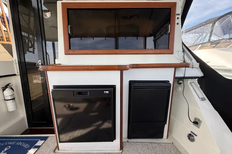 Slide: The Image of 1989 Carver 3807 Aft Cabin Motor Yacht interior with fridge and storage. - 14
