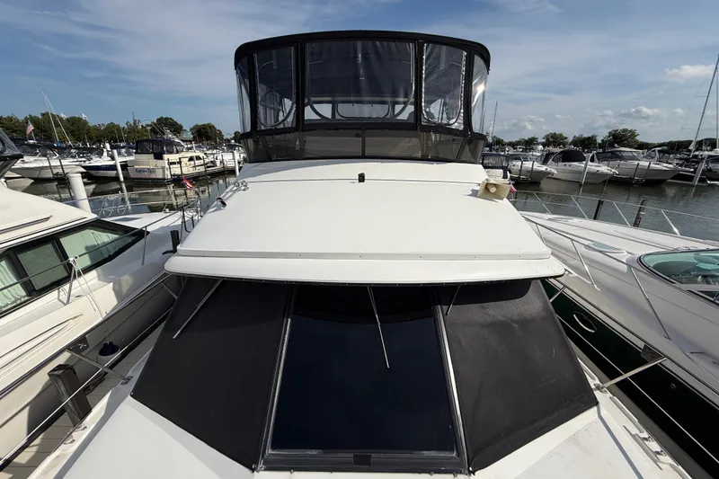 Slide: The Image of 1989 Carver 3807 Aft Cabin Motor Yacht docked at marina, surrounded by other boats. - 4