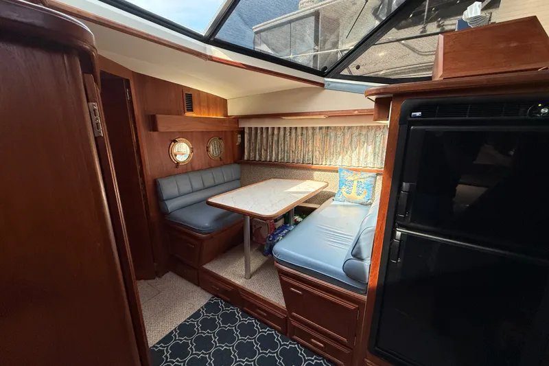 Slide: The Image of Interior of 1989 Carver 3807 Aft Cabin Motor Yacht with cozy dining area. - 49
