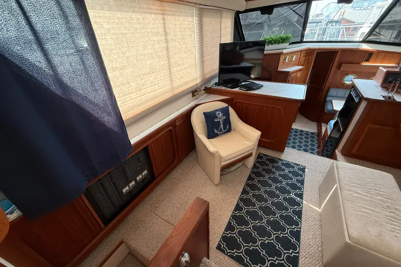 Slide: The Image of Interior of 1989 Carver 3807 Aft Cabin Motor Yacht with cozy seating and nautical decor. - 29