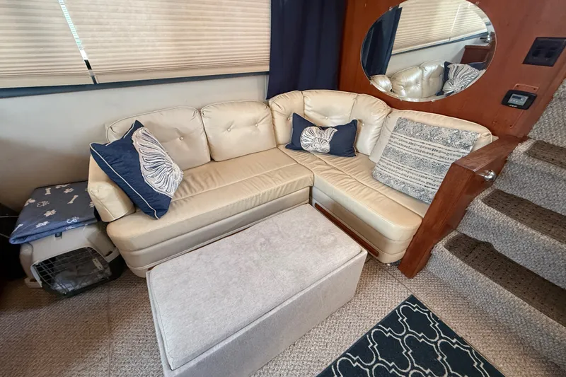 Slide: The Image of Cozy interior of 1989 Carver 3807 Aft Cabin Motor Yacht with beige seating and nautical decor. - 31