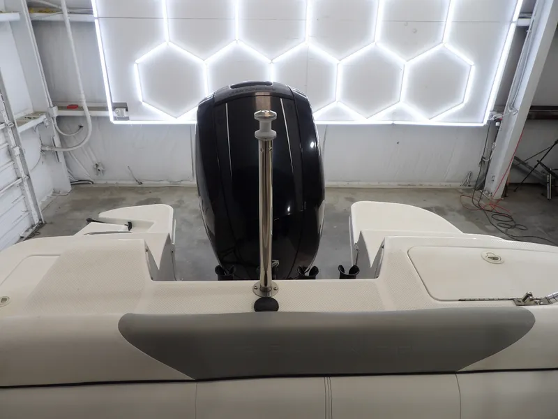 Slide: The Image of The image shows the stern of a 2013 Bayliner 190 Deck Boat with an outboard motor. - 23