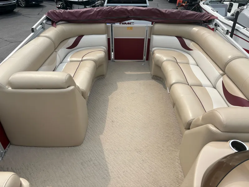 Slide: The Image of The image shows the interior of a 2012 Crest Classic 230L with beige and red seating. - 12