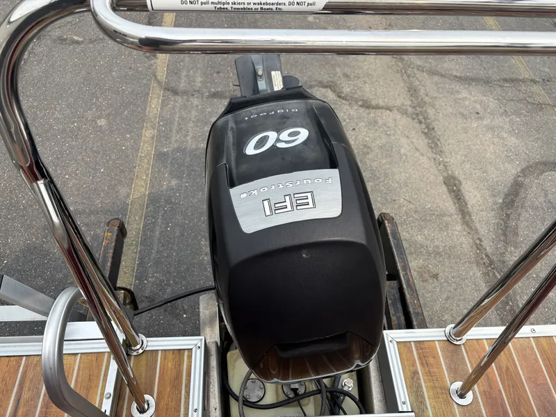 Slide: The Image of An outboard motor labeled "EFI FourStroke 60" is mounted on a boat. - 7