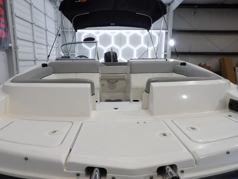 Slide: The Image of The image shows the spacious stern of a 2013 Bayliner 190 Deck Boat in a warehouse. - 10