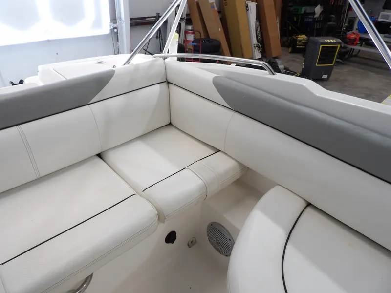 Slide: The Image of The image shows the white upholstery in the seating area of a 2013 Bayliner 190 Deck Boat. - 22