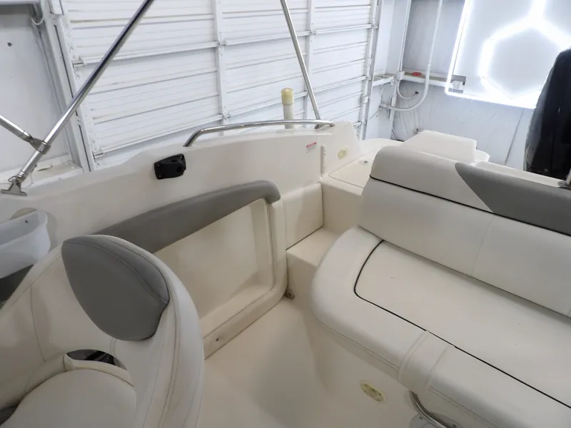 Slide: The Image of The image shows the interior of a 2013 Bayliner 190 Deck Boat with white seating. - 20