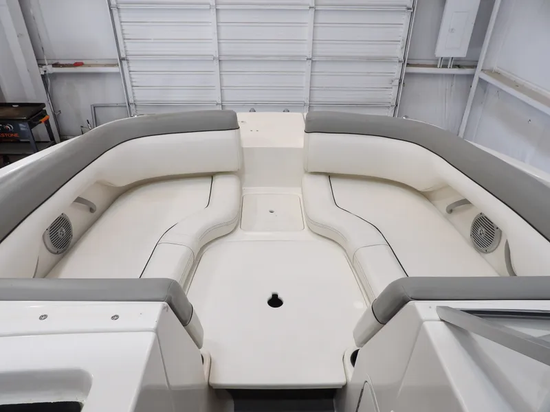 Slide: The Image of The image shows the bow area of a 2013 Bayliner 190 Deck Boat with white upholstery. - 13
