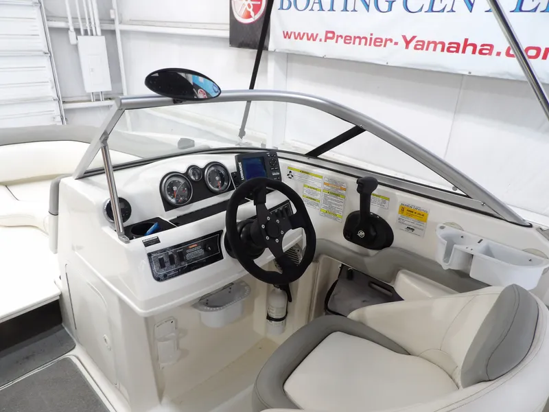 Slide: The Image of The image shows the cockpit of a 2013 Bayliner 190 Deck Boat with steering wheel and instruments. - 17