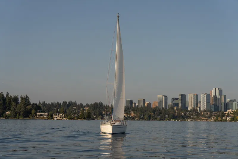 Slide: The Image of Sailboat Catalina 400 MkII (2000) on calm water with city skyline backdrop. - 2