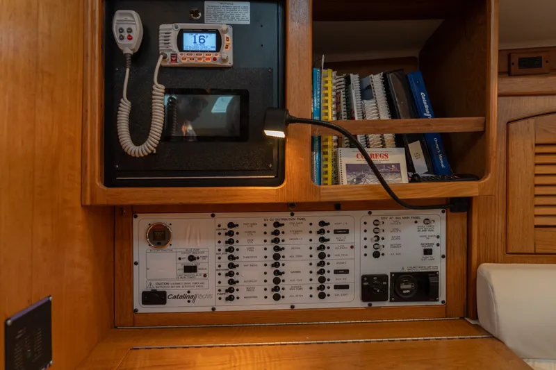 Slide: The Image of Control panel and radio on a 2000 Catalina 400 MkII yacht, with manuals and books. - 29