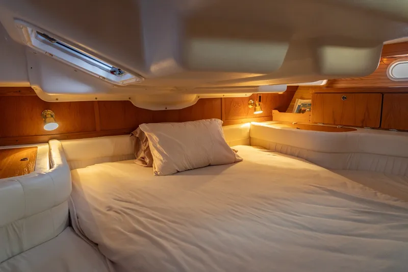 Slide: The Image of Cozy cabin interior of 2000 Catalina 400 MkII sailboat with warm lighting and wood accents. - 30