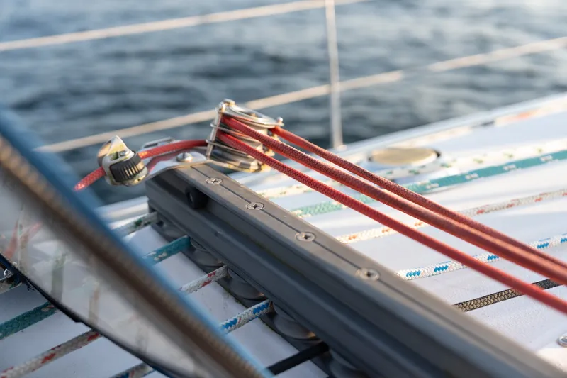 Slide: The Image of Close-up of Catalina 400 MkII sailboat rigging, featuring red ropes and deck hardware. - 15