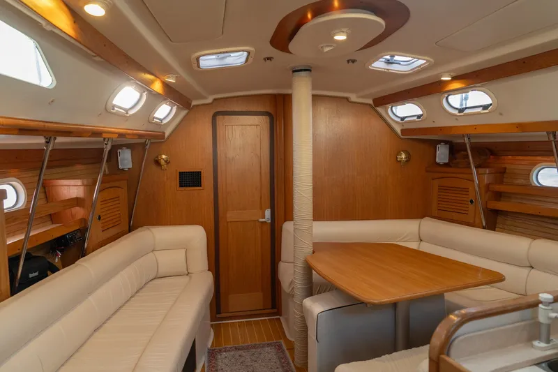 Slide: The Image of Interior of 2000 Catalina 400 MkII sailboat with wood accents and beige seating. - 19