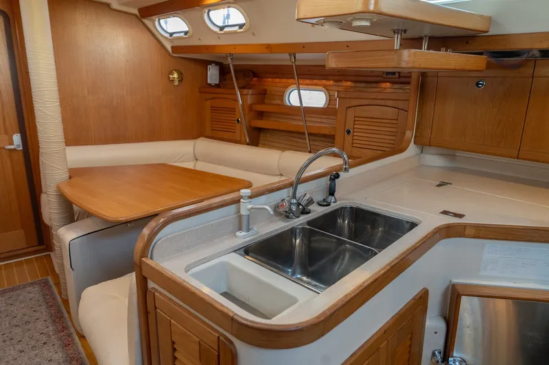 Slide: The Image of Interior of a 2000 Catalina 400 MkII sailboat with kitchen and dining area. - 21