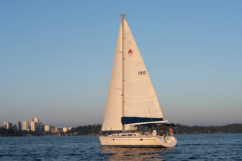 Slide: The Image of Catalina 400 MkII sailboat from 2000 on calm water with city skyline backdrop. - 46