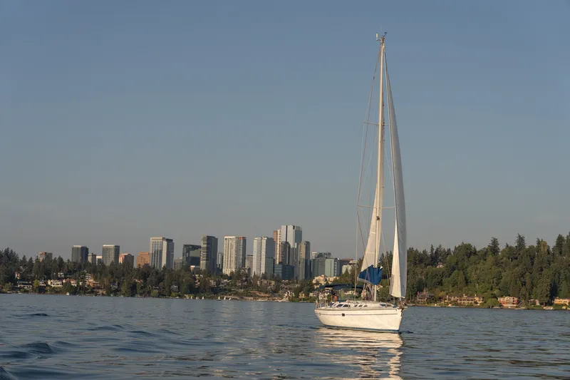 Slide: The Image of Sailboat Catalina 400 MkII (2000) on calm water with city skyline backdrop. - 1