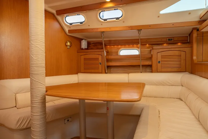 Slide: The Image of Interior of 2000 Catalina 400 MkII sailboat with cozy seating and wooden table. - 25