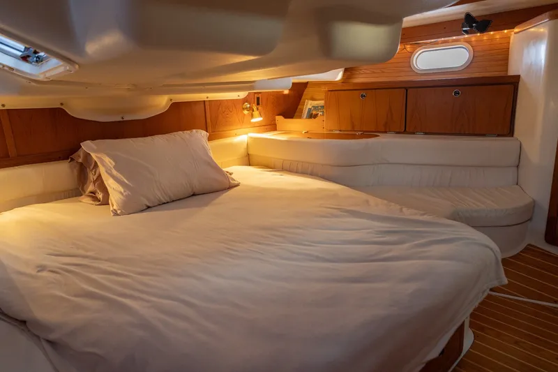 Slide: The Image of Cozy cabin interior of 2000 Catalina 400 MkII sailboat with comfortable bedding and warm lighting. - 31