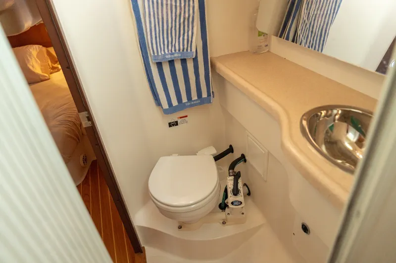 Slide: The Image of Compact bathroom in a 2000 Catalina 400 MkII yacht with toilet, sink, and striped towel. - 34