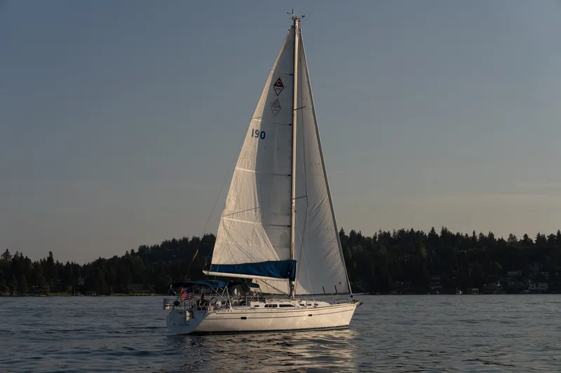 The Image of Sailing yacht Catalina 400 MkII 2000 on calm water with forested shoreline. - 0