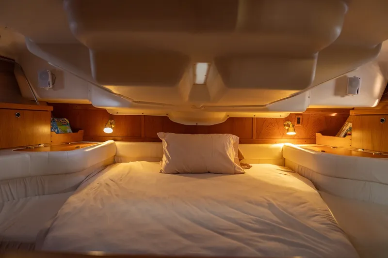 Slide: The Image of Cozy cabin interior of 2000 Catalina 400 MkII sailboat with warm lighting and comfortable bedding. - 32