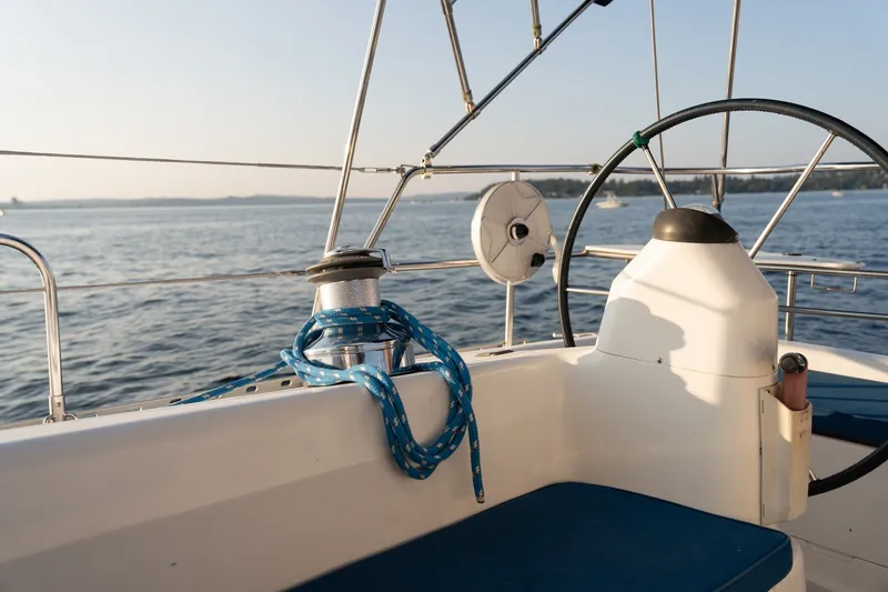 Slide: The Image of Cockpit of 2000 Catalina 400 MkII sailboat with steering wheel and blue rope. - 11