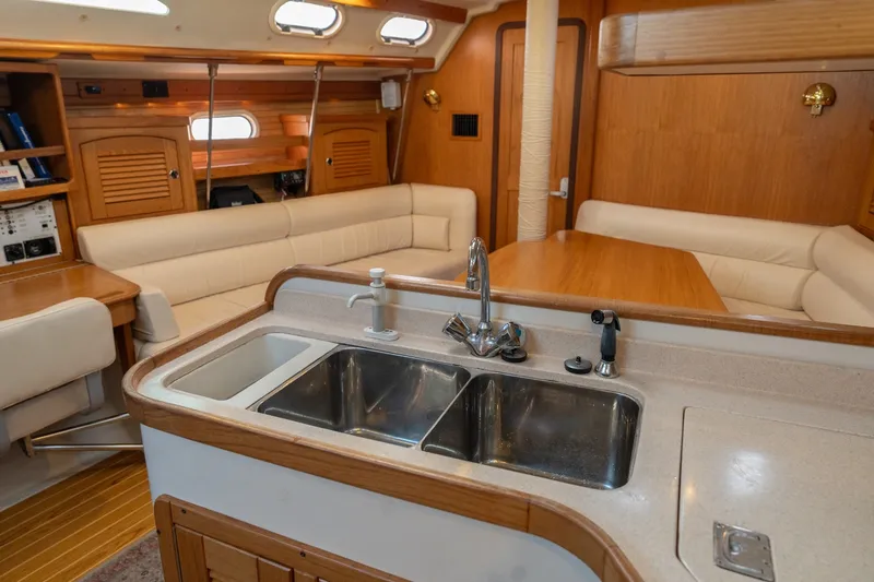Slide: The Image of Interior of a 2000 Catalina 400 MkII yacht with a modern kitchen and seating area. - 22