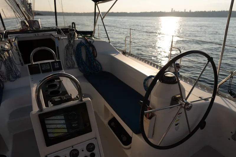 Slide: The Image of Cockpit of 2000 Catalina 400 MkII sailboat with steering wheel, overlooking serene water. - 7