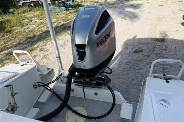 Slide: The Image of Outboard motor on Gospel Boat Florida Landing Craft 9m, 2022 model, parked on sandy terrain. - 10