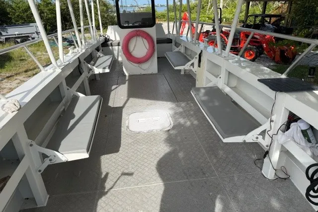 Slide: The Image of Interior of 2022 Gospel Boat Florida Landing Craft 9m with seating and life preserver. - 1